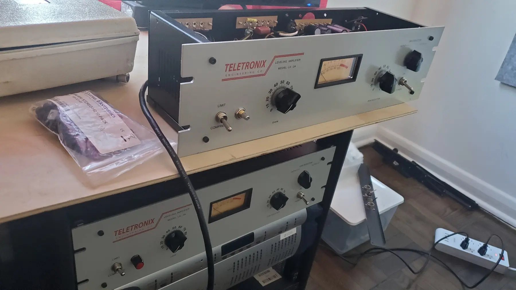 Two completed LA-2A style optical limiters on a builder's bench