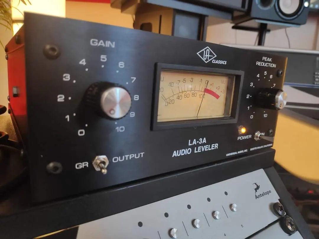 Black LA-3A style audio leveler in a studio rack