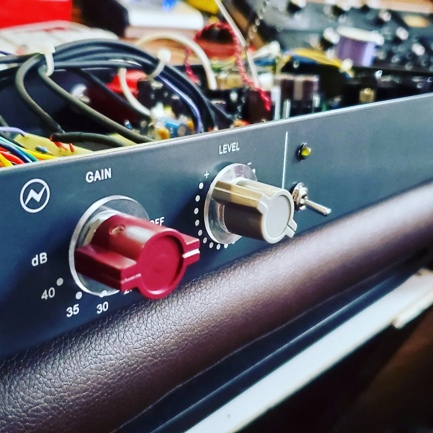 Close-up of red and cream controls on a custom preamplifier